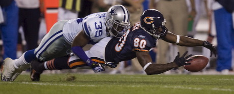 Chicago Bears wide receiver Bernard Berrian is hit by Dallas