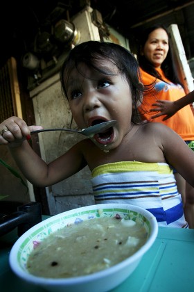 Filipino Child Eats Rice Porridge Along Editorial Stock Photo - Stock ...