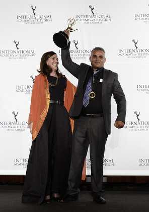 Producer Christine Camdessus (l) and Palestinian Director Emad Burnat (r) Hold Up Their Award For the Documentary Film '5 Broken Cameras' During the 41st International Emmy Awards Gala at a Hotel in New York New York Usa 25 November 2013 United States New York