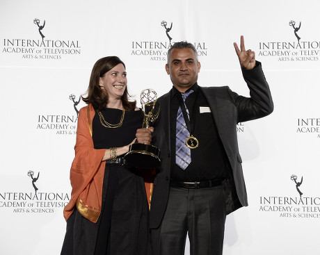 Producer Christine Camdessus (l) and Palestinian Director Emad Burnat (r) Hold Up Their Award For the Documentary Film '5 Broken Cameras' During the 41st International Emmy Awards Gala at a Hotel in New York New York Usa 25 November 2013 United States New York