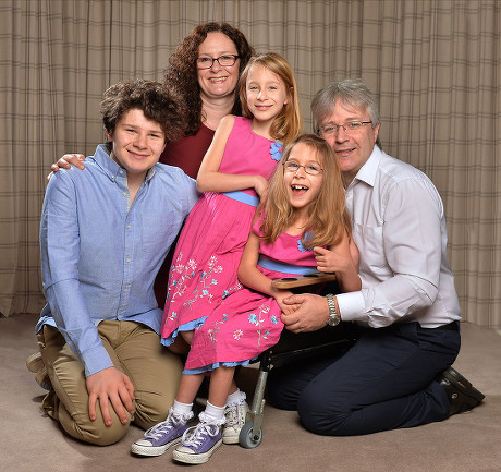 Seven Year Old Disabled Girl Rebecca Carey (glasses) Pictured With Her Twin Sister Charlotte Brother Joe Mum Pamela And Dad Tim At Their Home In Congleton Cheshire. Rebecca Needs Selective Dorsal Rhizotomy (sdr) Surgery In The Usa To Walk Again And I