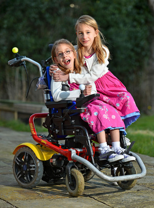 Seven Year Old Disabled Girl Rebecca Carey (glasses) Pictured With Her Twin Sister Charlotte At Their Home In Congleton Cheshire. Rebecca Needs Selective Dorsal Rhizotomy (sdr) Surgery In The Usa To Walk Again And Is Appealing To Dm Readers For Help.