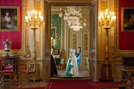 Fashioning A Reign: 90 Years Of Style From The Queen's Wardrobe At Windsor Castle - The Green Drawing Room Curator Caroline De Guitaut Adjusting A 1961 Norman Hartnell Dress Worn By The Queen At A State Banquet In On Her State Visit To Pakistan.