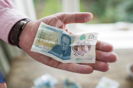 The New £5 Note. Harry Mount With The New Indestructible Plastic Five Pound Note Released Into Circulation 13th September 2016. Harry Tries Various Methods To Destroy It Including A Dishwasher Oven Washing Machine Iron Crumpling Folding Sofa Squash F