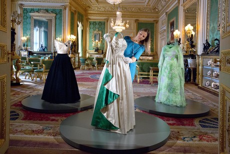 Fashioning A Reign: 90 Years Of Style From The Queen's Wardrobe At Windsor Castle - The Green Drawing Room Curator Caroline De Guitaut Adjusting A 1961 Norman Hartnell Dress Worn By The Queen At A State Banquet In On Her State Visit To Pakistan. On