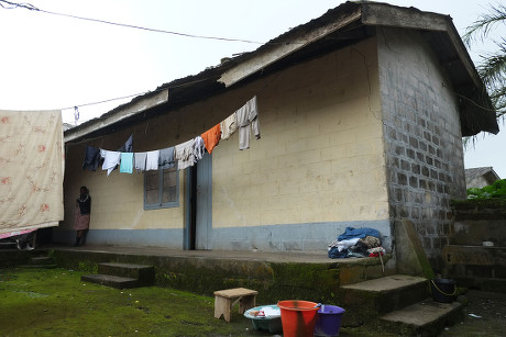 The Home In Buea Cameroon Where Jeanne Sube Grew Up With Her Family A Two Bedroom Apartment. The Complex Has Six Two Bedroom Apartments With Outside Kitchen Shower And Toilet Facilities. Picture Shows - Locked Kitchen Door(right) Toilet (left) And Sh