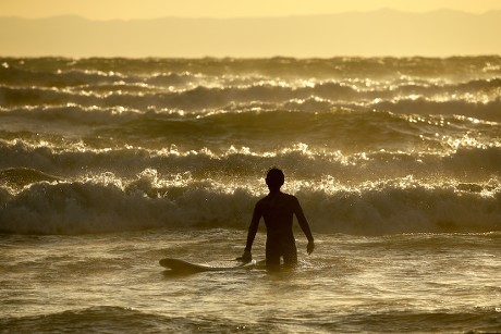 BEGINNER SURFER TRIES RIDE ON WAVE Editorial Stock Photo photo