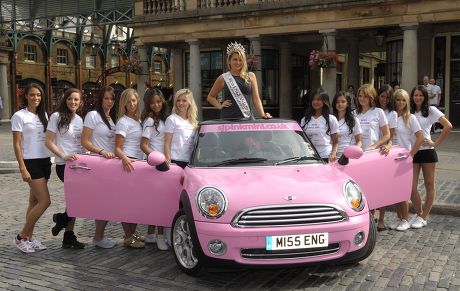 Miss England finalists attempt to drag a pink convertible Mini car, London, Britain - 14 Jul 2009
