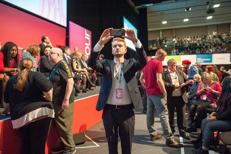 Jeremy Corbyn's Speech On The Final Day Of Labour Party Conference In Brighton. Corbyn's Son Thomas Corbyn Takes A Picture Of The Auditorium.