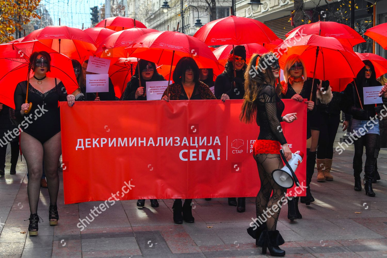 Macedonian Sex Workers Carrying Red Umbrellas Walk