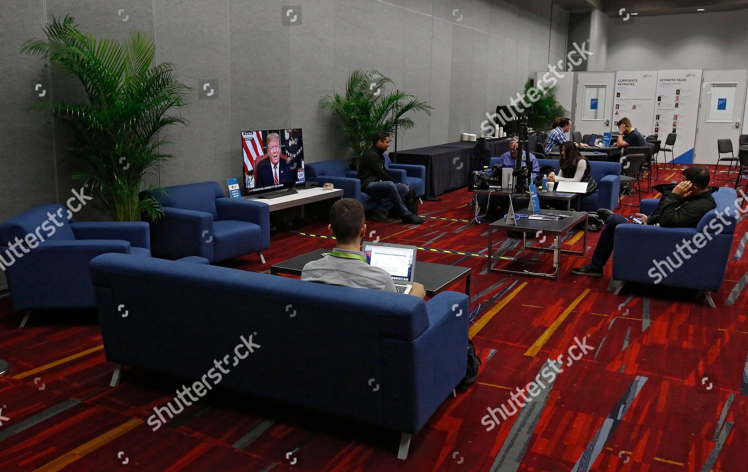 People Sit On Couches Inside Media Room Editorial Stock