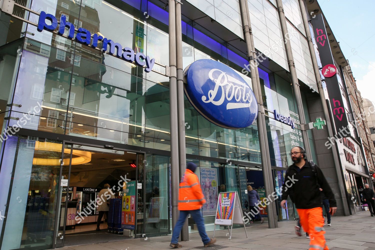 Shoppers walk past Boots store on Oxford Editorial Stock