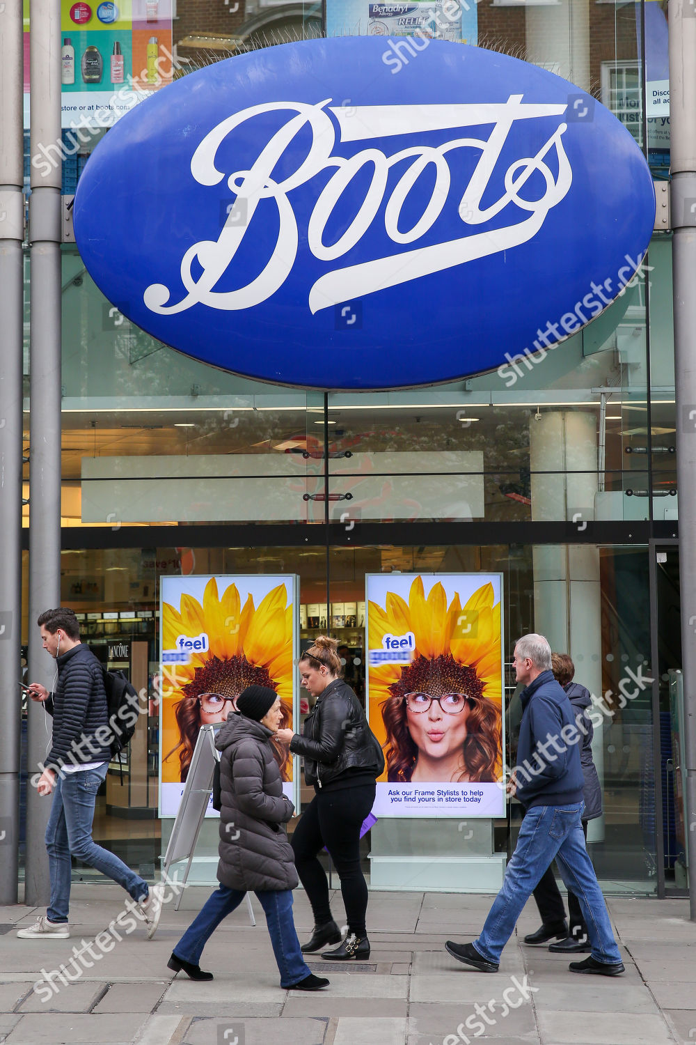 Shoppers walk past Boots store on Oxford Editorial Stock