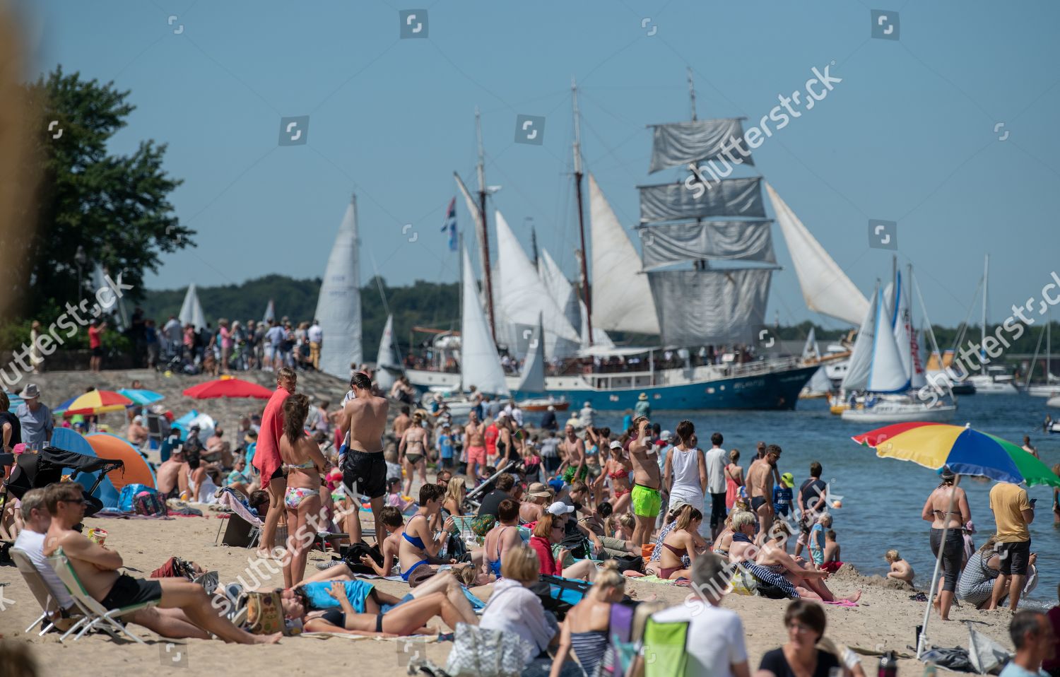 People Observe Traditional Sailing Ships During Windjammer
