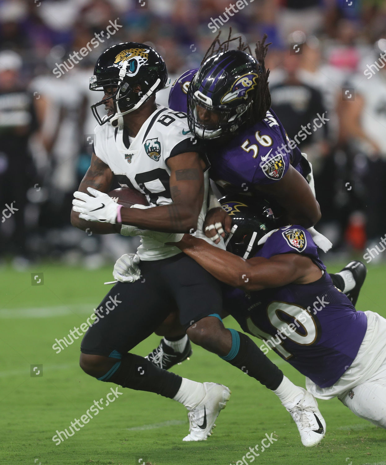 Baltimore, Maryland, USA. 08th Aug, 2019. Jacksonville Jaguars WR Tre  McBride (88) is tackled by Baltimore Ravens OLB Tim Williams (56) and ILB  Kenny Young (40) during a preseason game at M&T