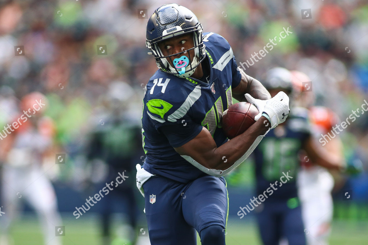 Seattle Seahawks wide receiver D.K. Metcalf (14) runs the ball on