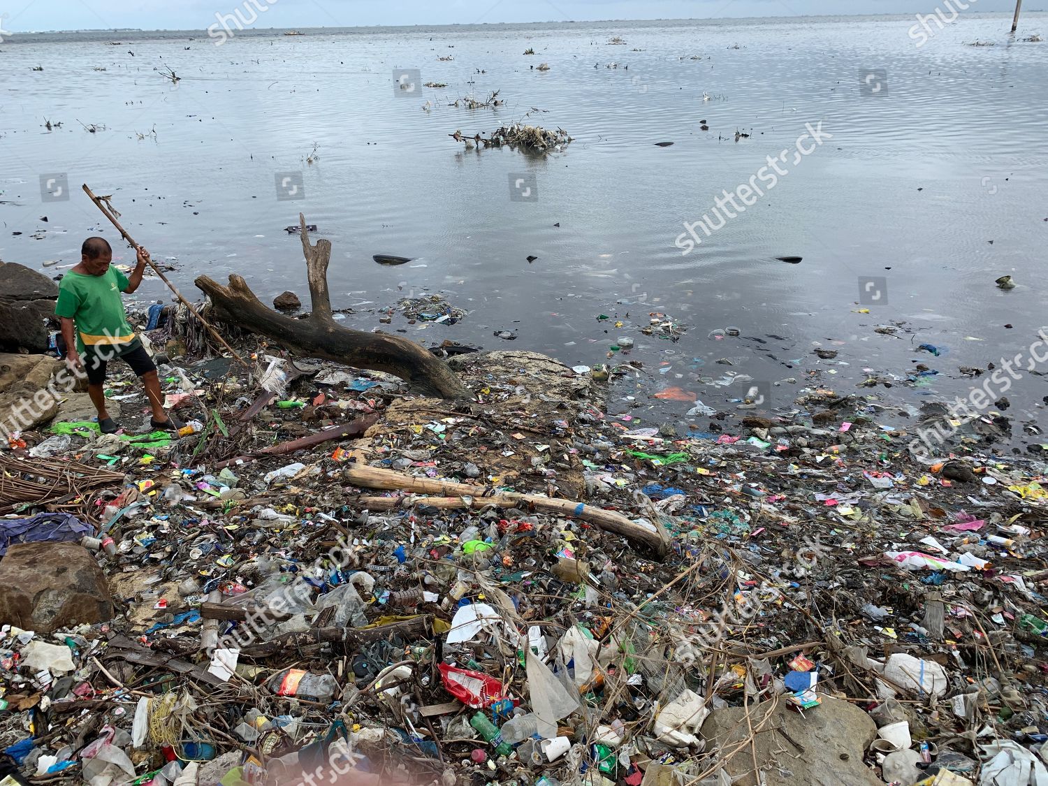 Filipino Villager Maneuvers Amongst Trash Along Editorial Stock Photo - Stock Image | Shutterstock | Shutterstock Editorial