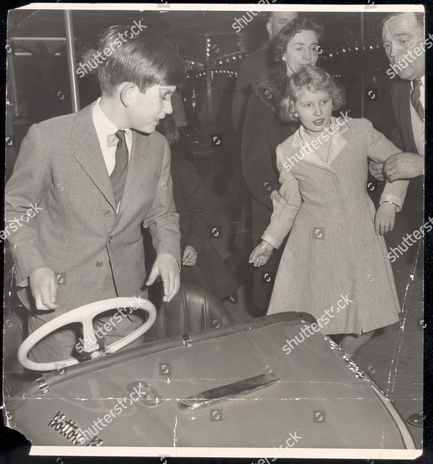 prince-charles-prince-of-wales-december-1959-a-helping-hand-for-the-princess-at-the-dodgems-first-it-was-the-dodgems-then-the-ghost-train-for-the-prince-of-wales-and-princess-anne-it-was-a-day-of-fun-and-laughter-fun-at-olympias-fair-after-shutterstock-editorial-1049852a.jpg