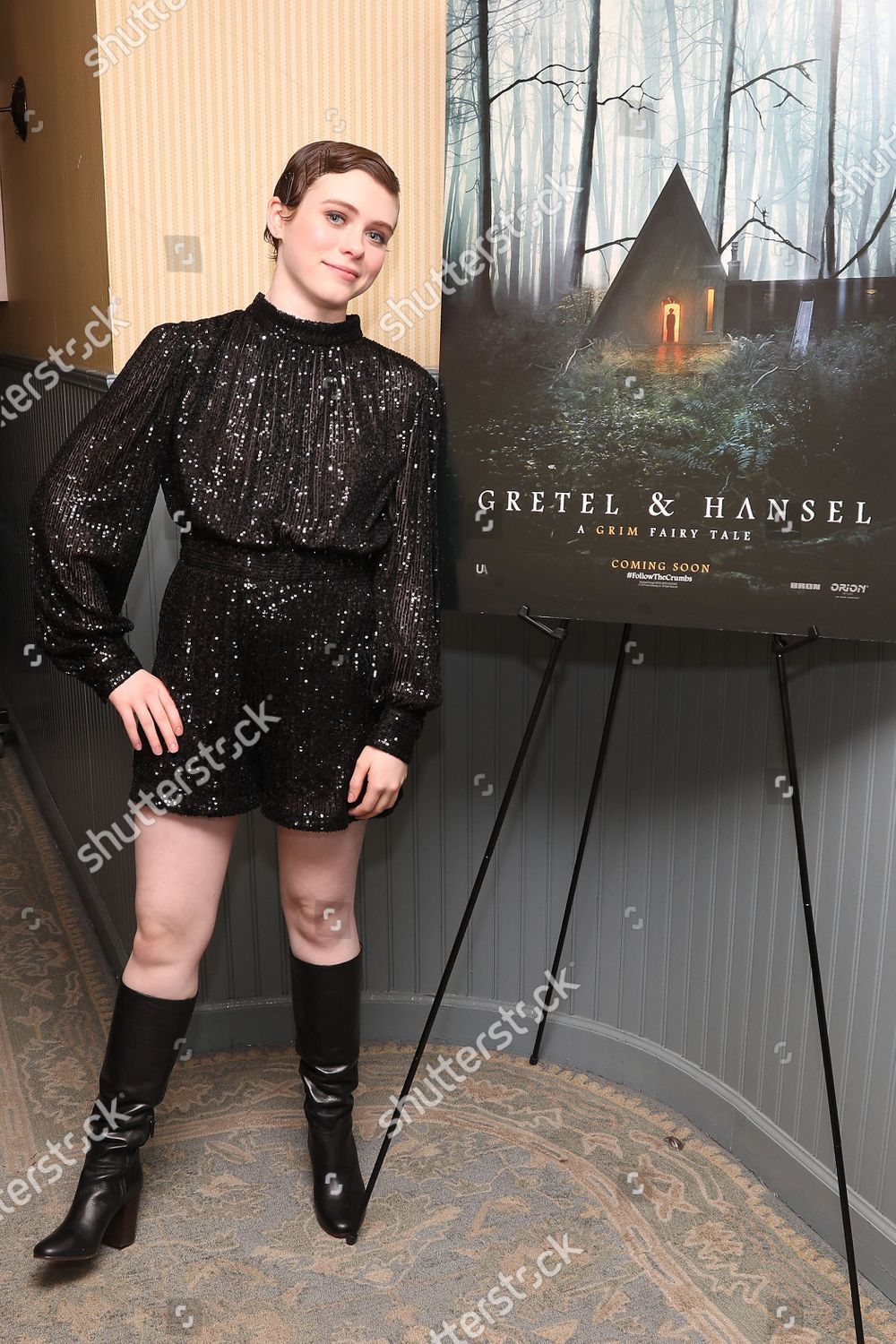 Black leather knee high boots worn by Sophia Lillis at New York Special