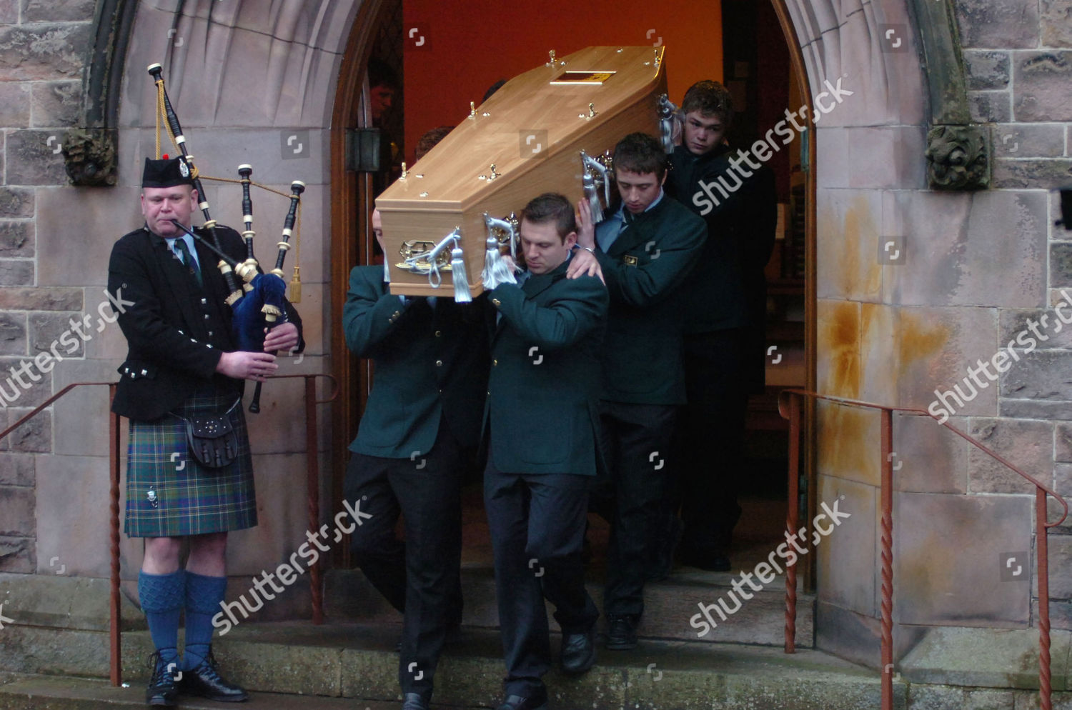 Coffin Leaves Church Accompanied By Traditional Pipe Editorial
