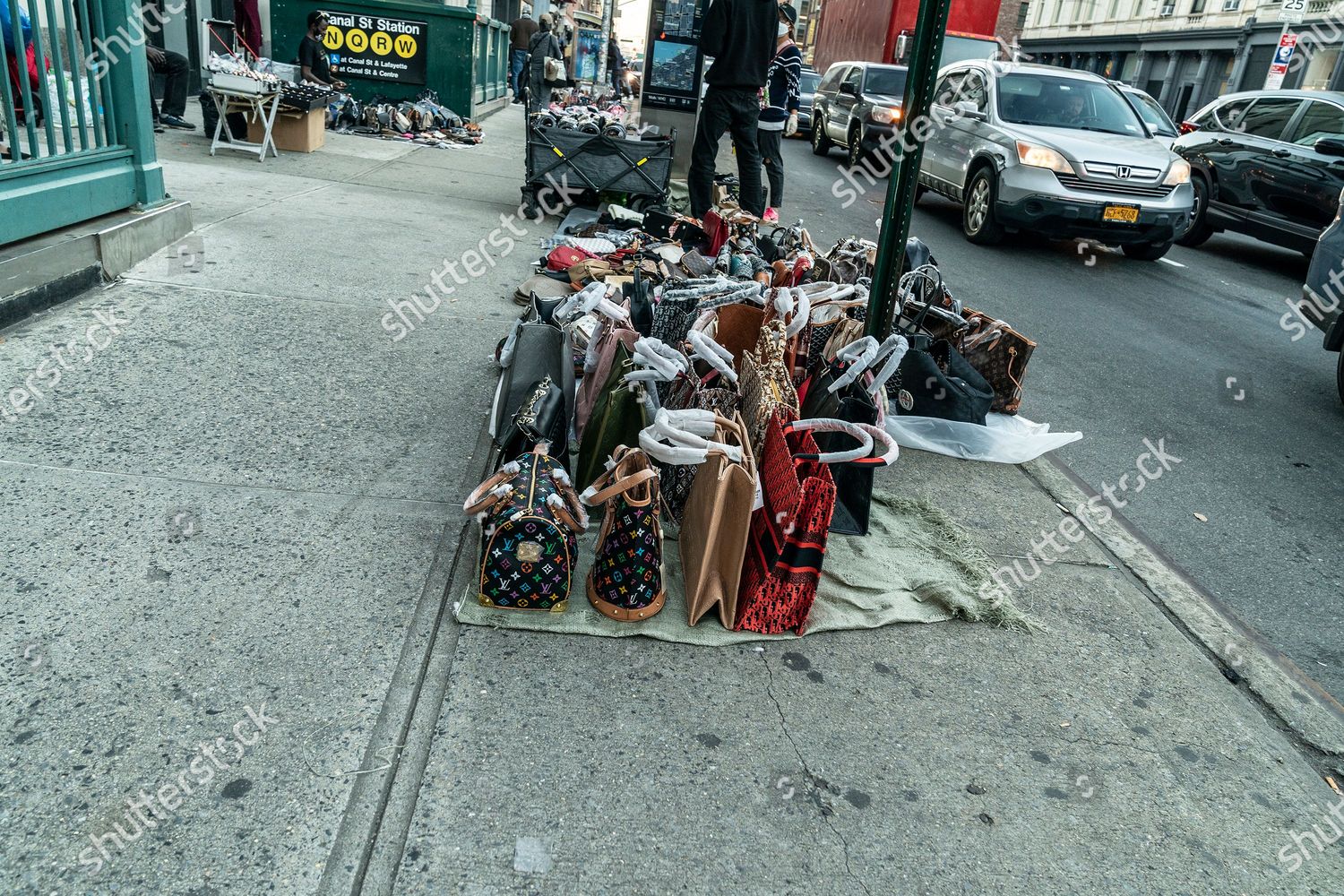 New York, United States. 09th Nov, 2020. Street vendors sell counterfeits  goods like bags, sunglasses, belts and watches on Canal street and Broadway  corners. Because of pandemic those sales are far and