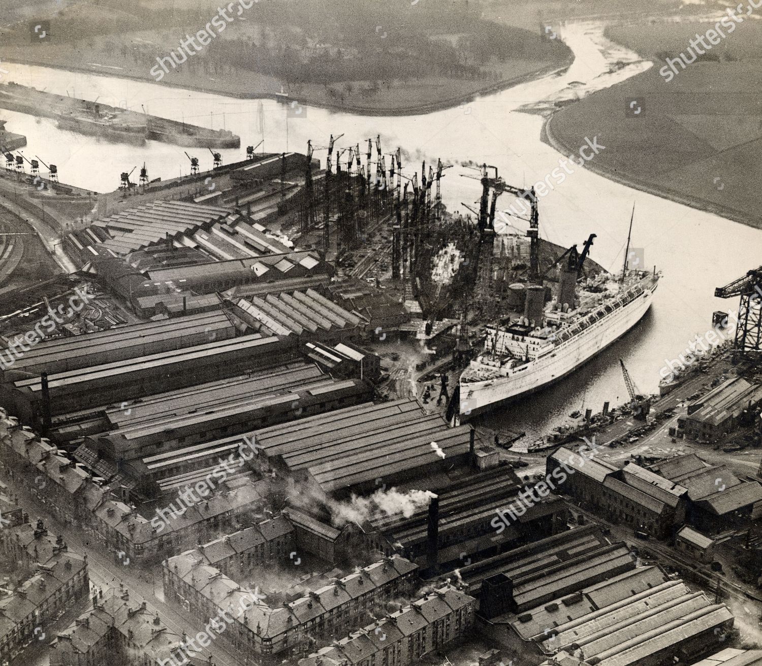 aerial-view-of-john-brown-co-ltd-shipyard-at-clydebank-liner-probably-the-empress-of-britain-is-having-its-third-funnel-fitted-alongside-two-navy-vessels-shutterstock-editorial-1105930a.jpg