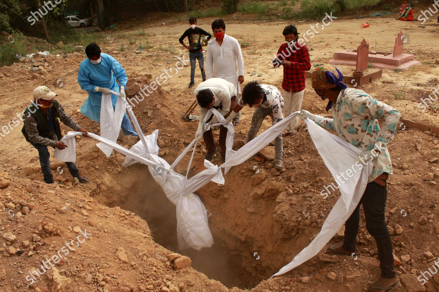 family-members-along-graveyard-workers-perform-editorial-stock-photo