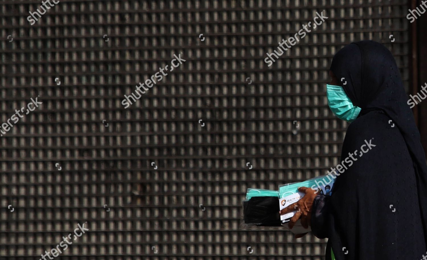 WOMAN SELLS FACE MASKS ON ROADSIDE Editorial Stock Photo Stock Image