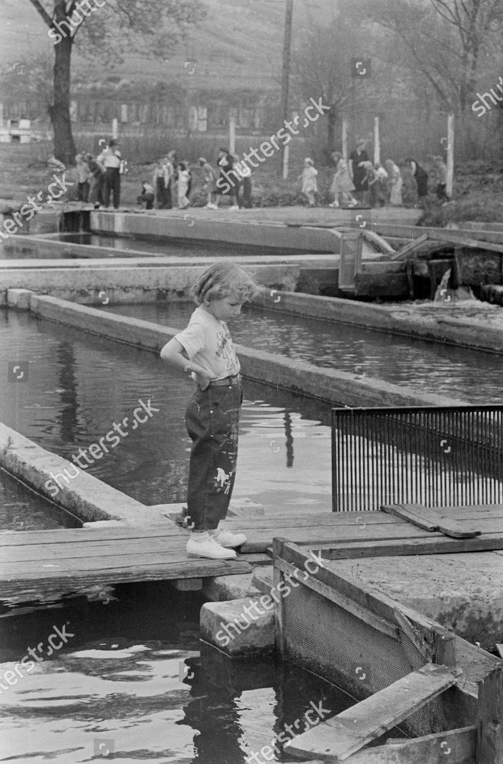 girl-watching-water-flow-during-their-editorial-stock-photo-stock