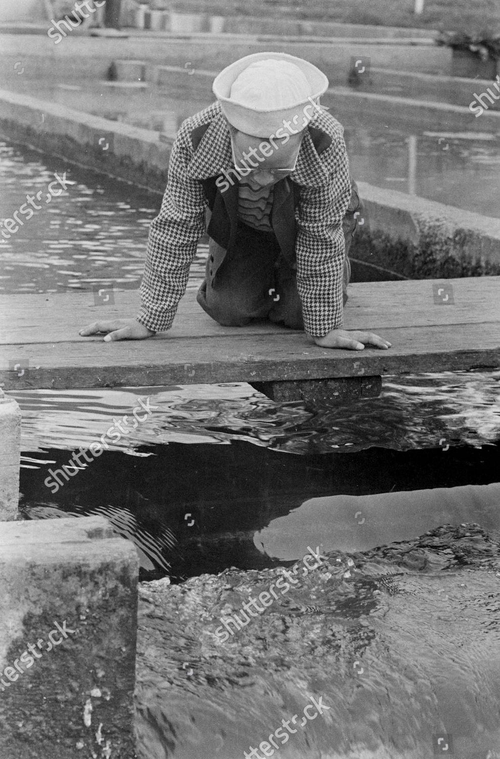 boy-watching-water-flow-during-their-editorial-stock-photo-stock