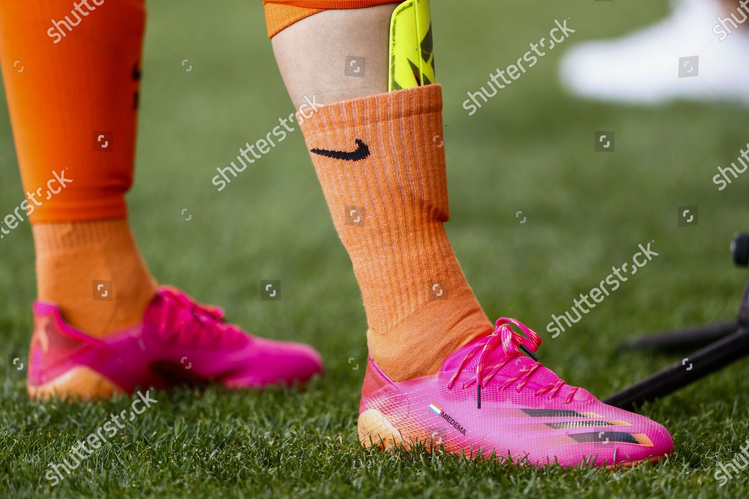 salmon pink football boots