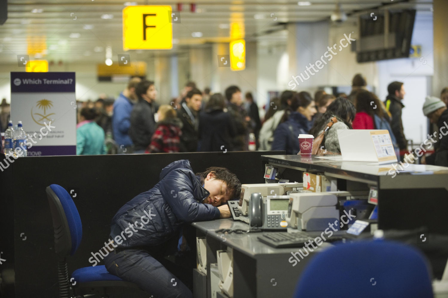 Passenger Sleeping Behind Checkin Desk Editorial Stock Photo