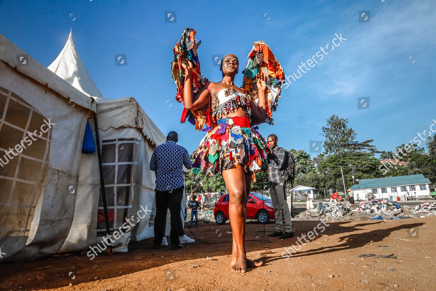 Nairobi, Kenya. 11th Dec, 2021. A young female model dressed in a colorful  outfit poses by the streets during the Mr. and Mrs. Kibera modeling contest  in Kibera Slums. Young models and