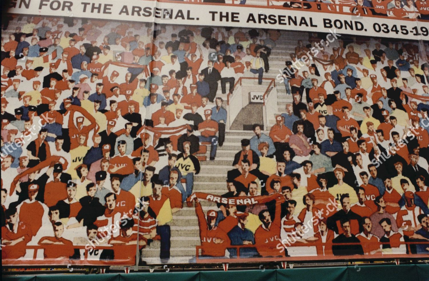 Stock photo of Controversial Mural At Highbury Football Ground. The Mural Designed To Hide Building Work On The North Bank Of The Ground Has Been Criticised For Only Showing White Arsenal Fans.