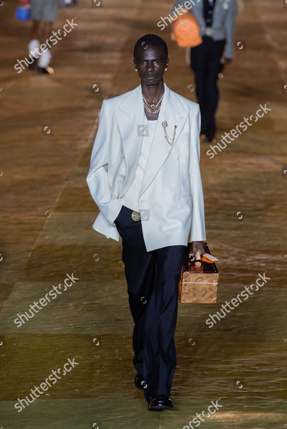 A model, bag detail, walks the runway during the Louis Vuitton