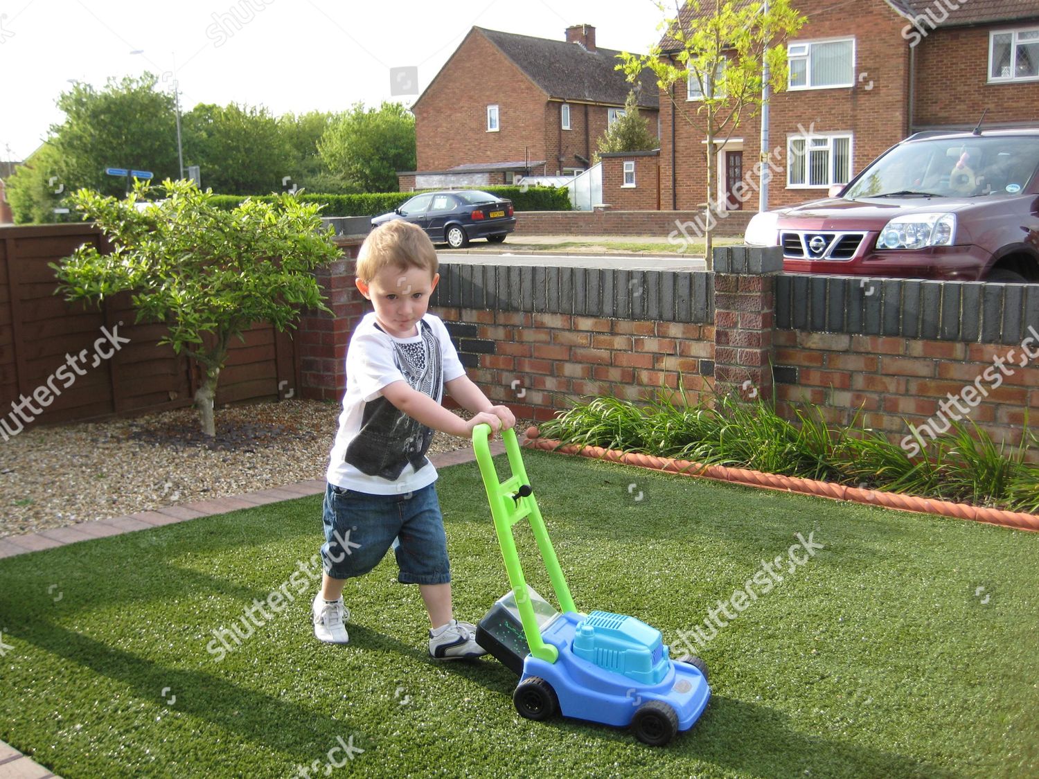 Astro Turf Garden >> Steve Woolnoughs Grandson Mowing Astro Turf Before Editorial Astro Turf Garden >> Steve Woolnoughs Grandson Mowing Astro Turf Before Editorial