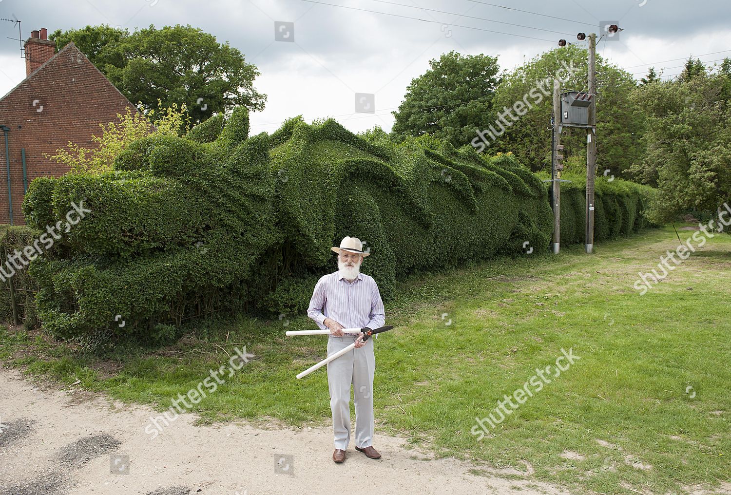 https://editorial01.shutterstock.com/wm-preview-1500/4827095a/dde1821c/retired-75-year-old-john-brooker-from-bagthorpe-norfolk-who-has-created-an-impressive-dragon-design-from-the-hedge-bordering-his-garden-the-former-fan-maker-got-his-inspiration-from-his-time-serving-for-the-army-in-the-far-east-in-the-1960s-npictu-shutterstock-editorial-4827095a.jpg