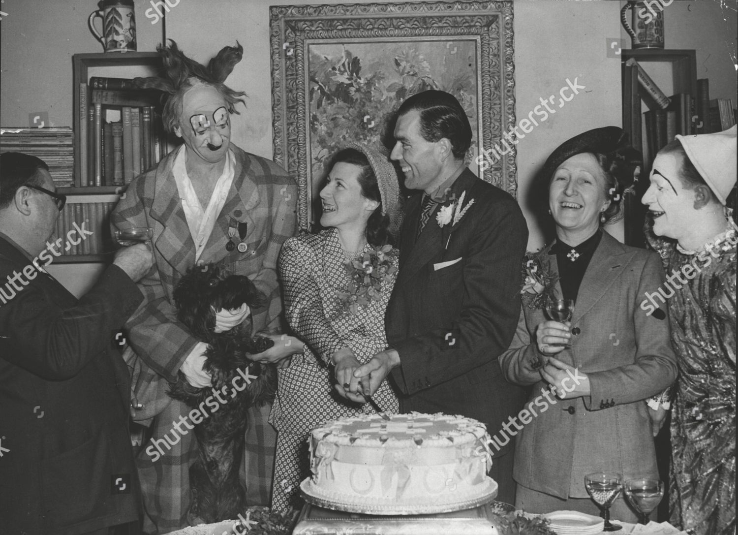 sculptor barney seale toasts the bride and groom his daughter zana seale and harold sirett on their wedding day watched by coco the clown mrs seale and cocos son michael box 0604 06072015 00210a jpg shutterstock editorial 4909343a