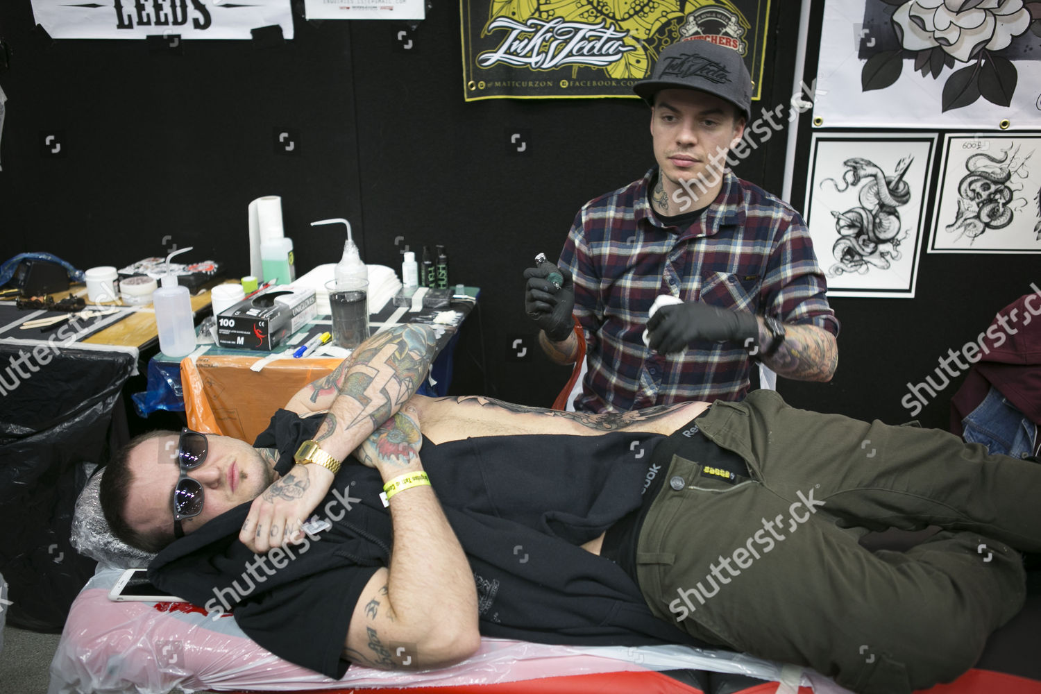 People get tattooed Brighton Tattoo convention Editorial Stock Photo