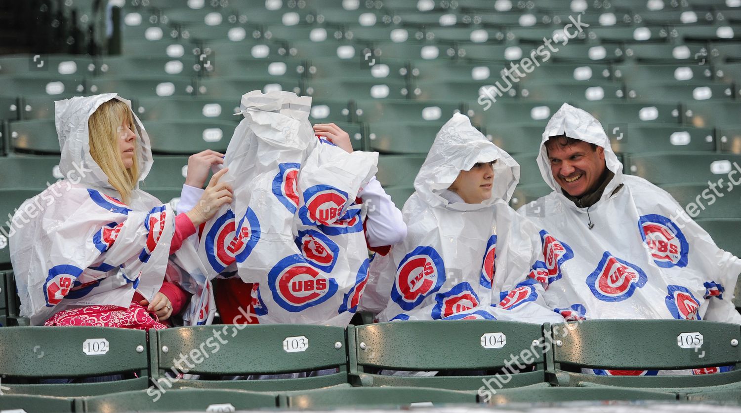 Fans struggle to put on ponchos in rain 