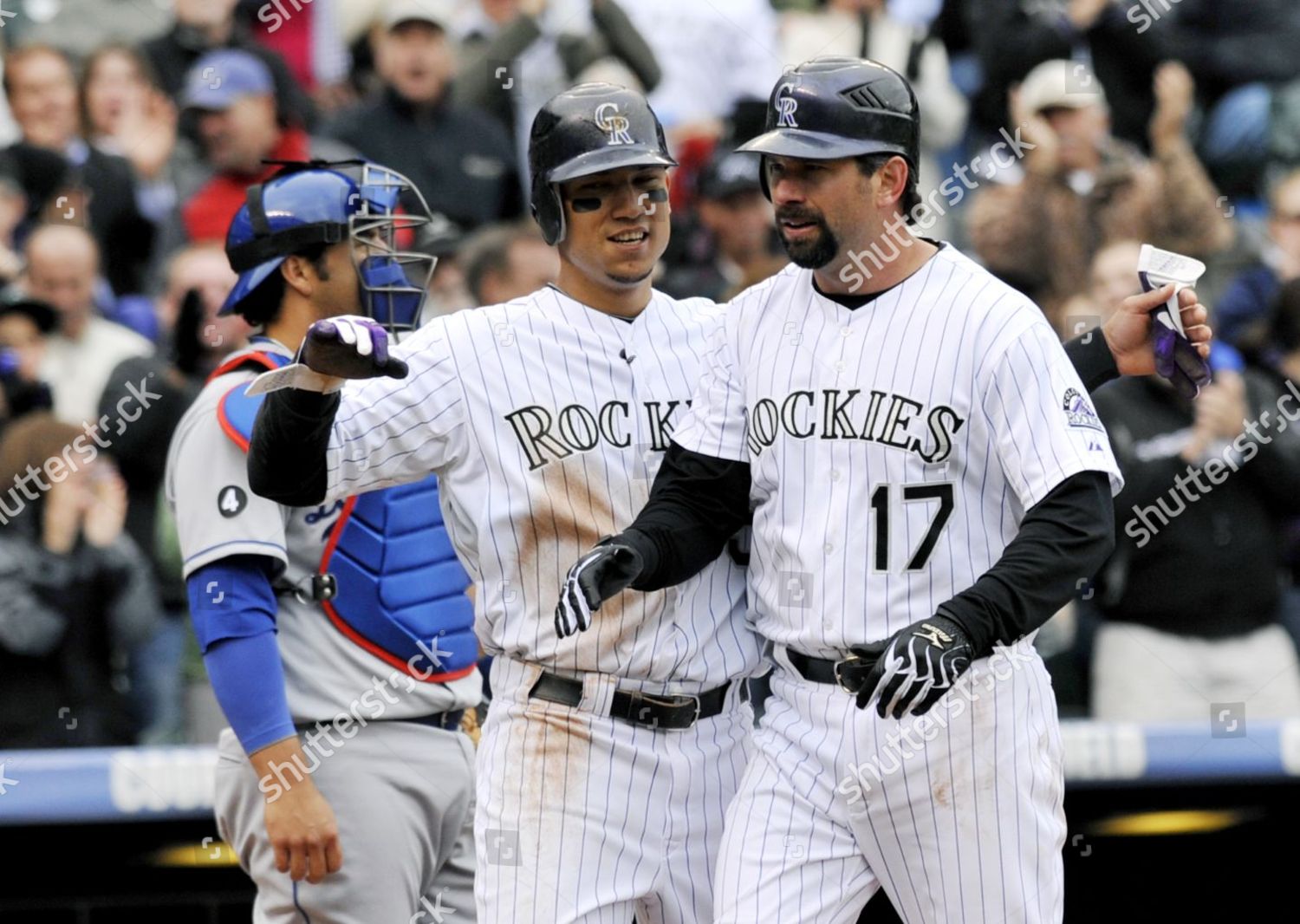 Colorado Rockies' Todd Helton (17) is congratulated by teammate