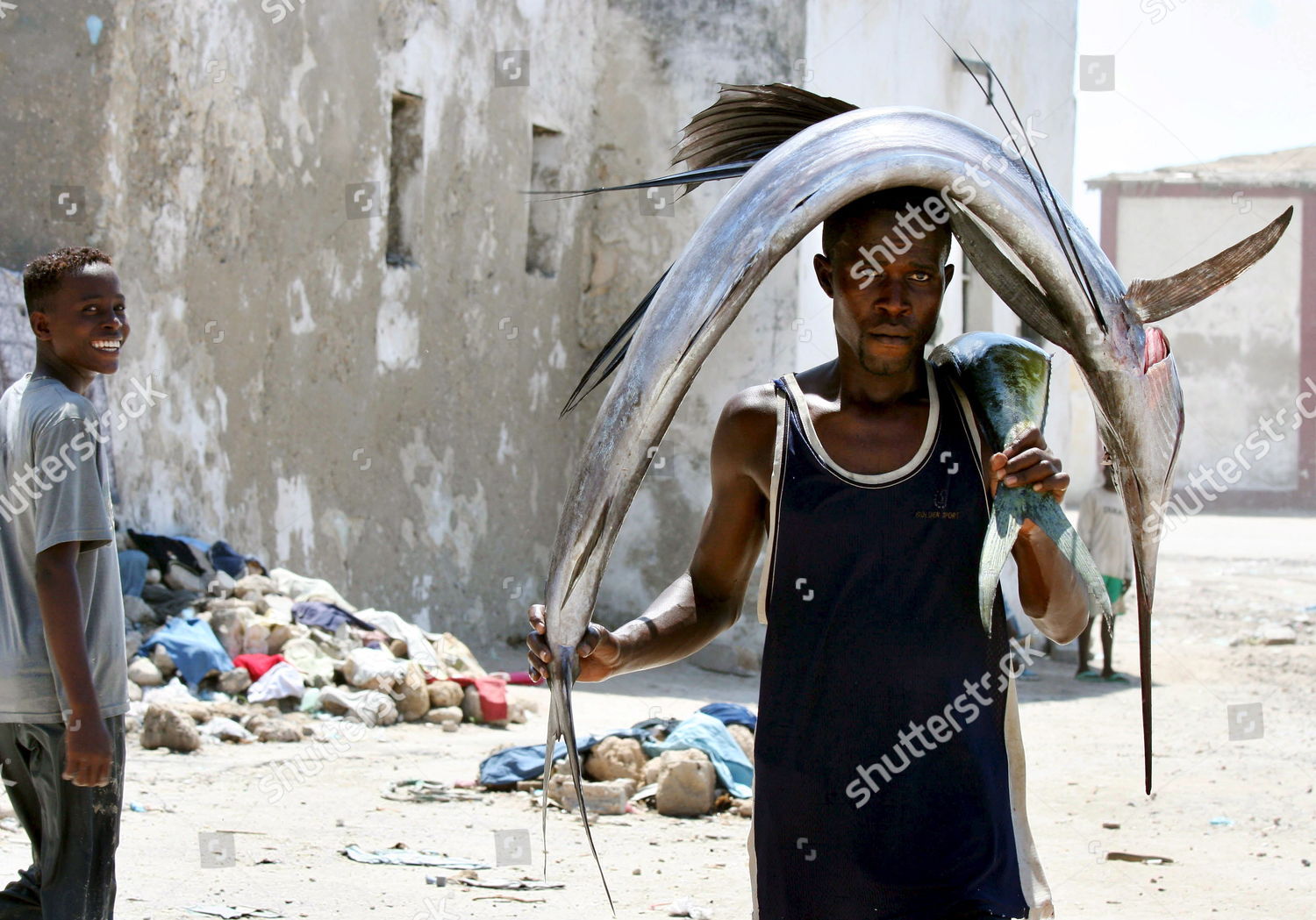 Somali Fisherman Carries Swordfish On His Editorial Stock Photo - Stock ...
