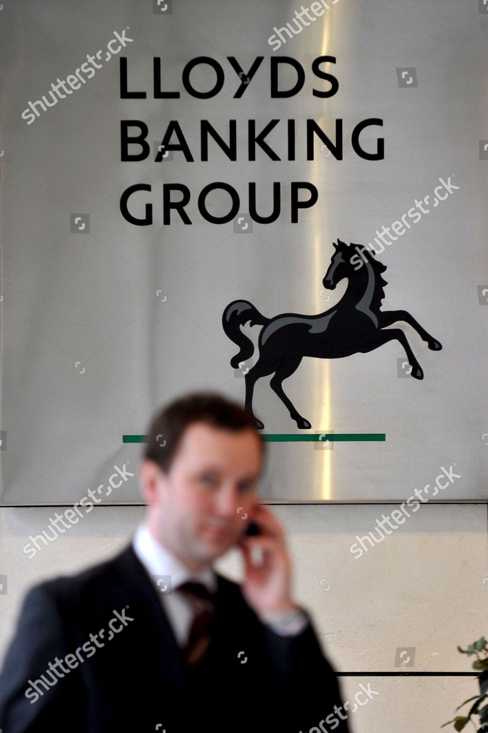 Man Walks Past Lloyds Banking Group Logo Editorial Stock Photo
