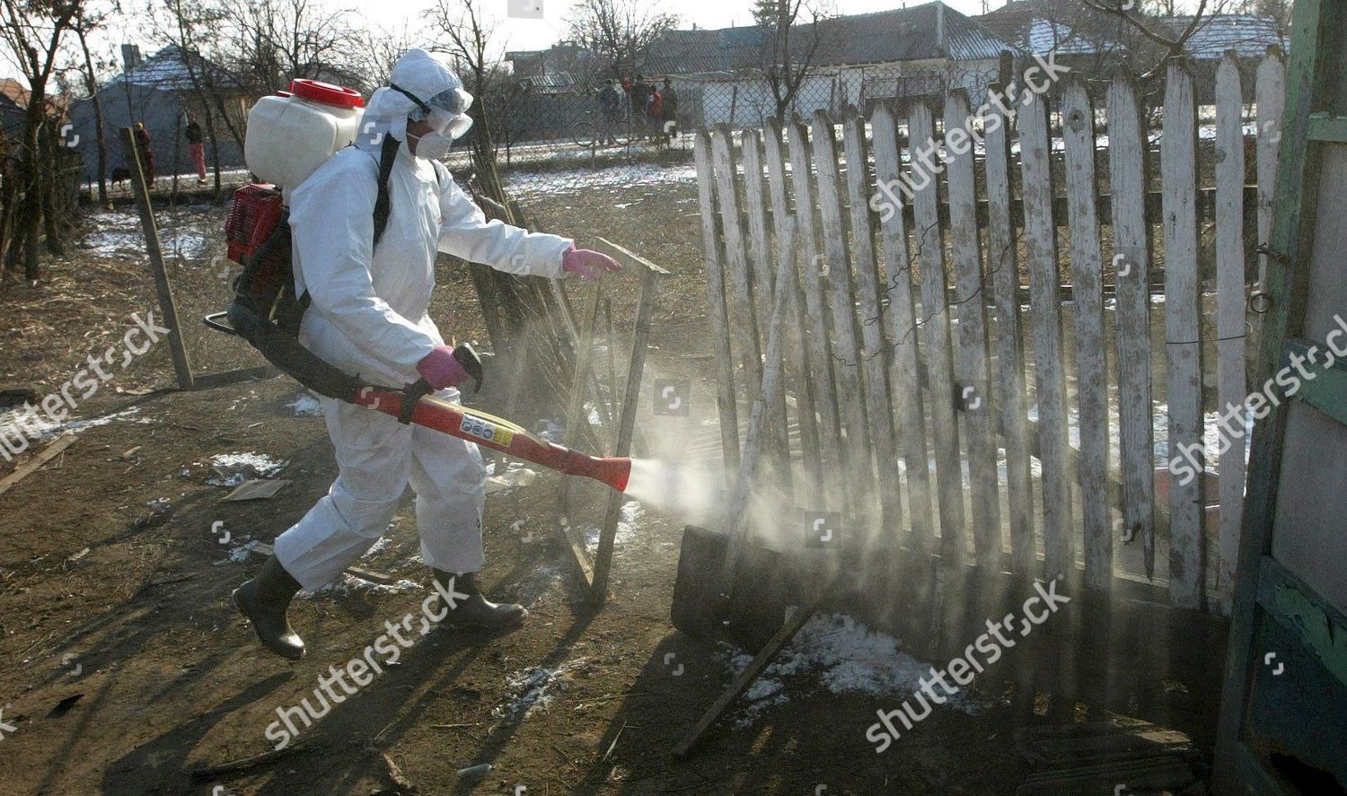 Romanian Veterinary Worker Sprays Disinfectant On Peasant