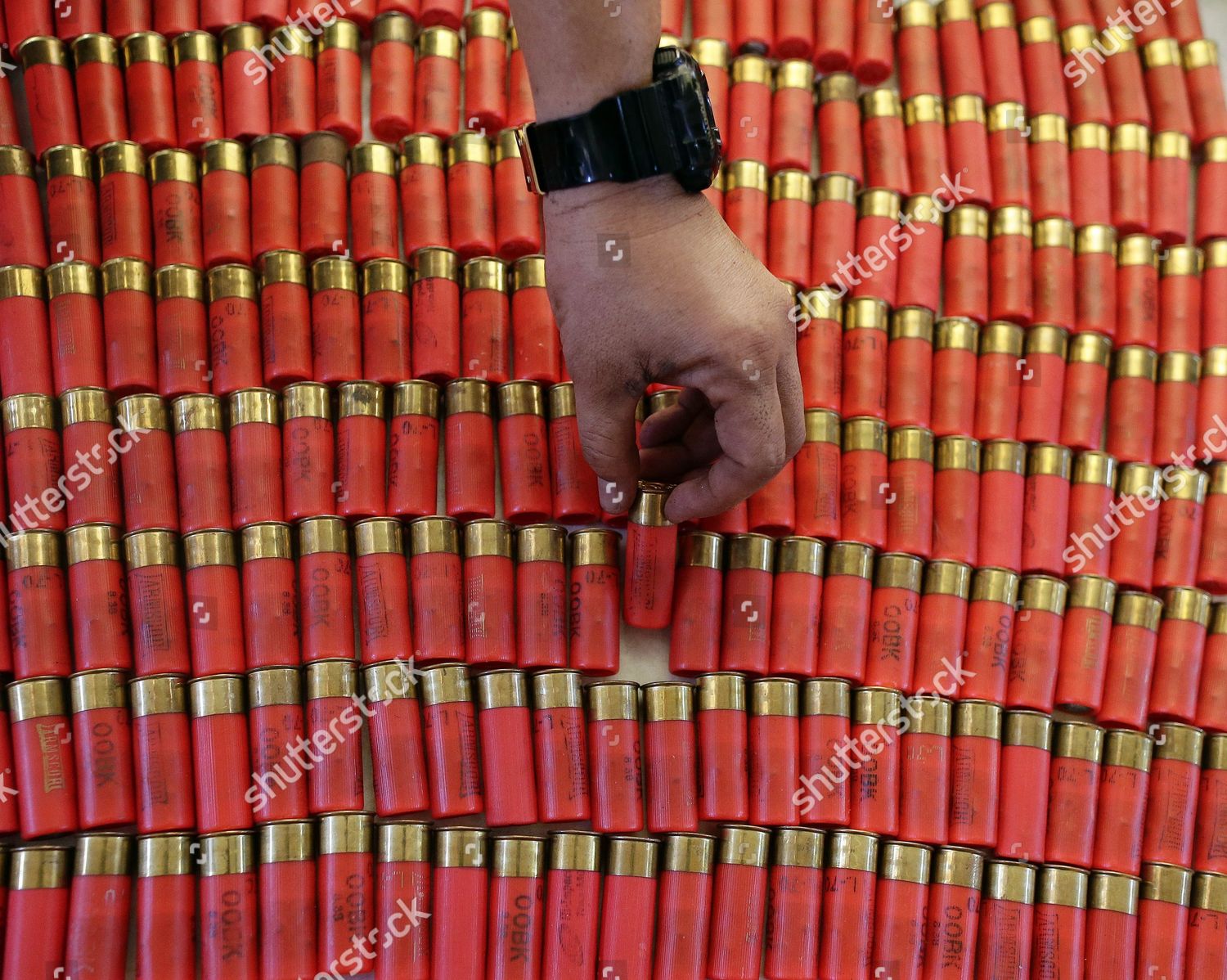 filipino-jail-officer-inspects-confiscated-shotgun-editorial-stock