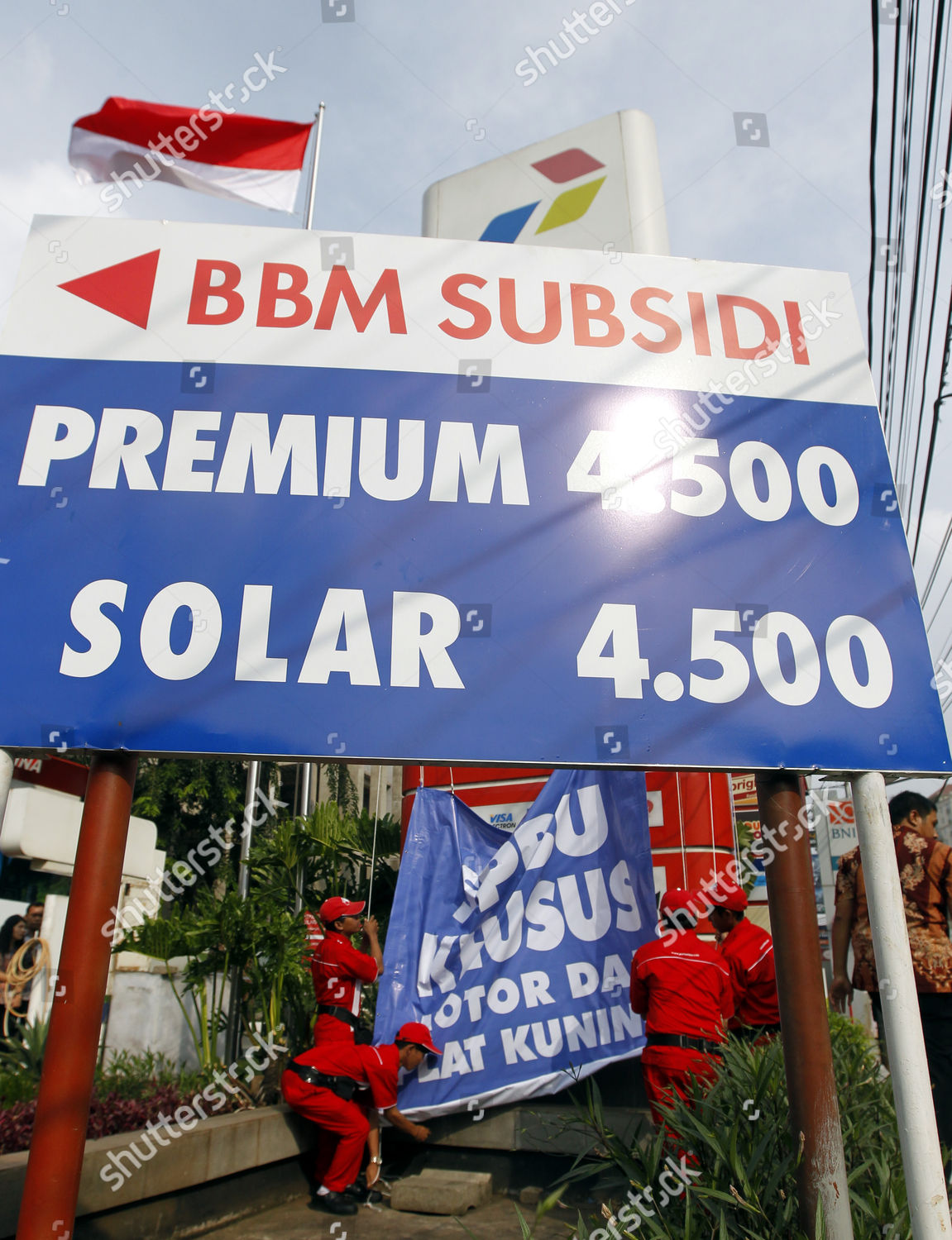 Indonesian Pertaminas Employees Set Banner Petrol Station