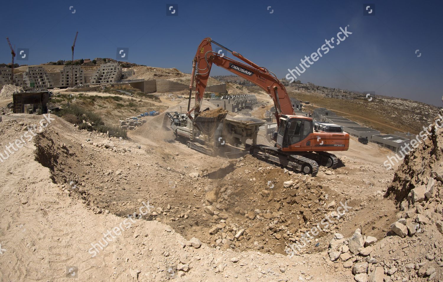 Earth Mover Dumping Rocks Into Crusher Editorial Stock Photo - Stock ...