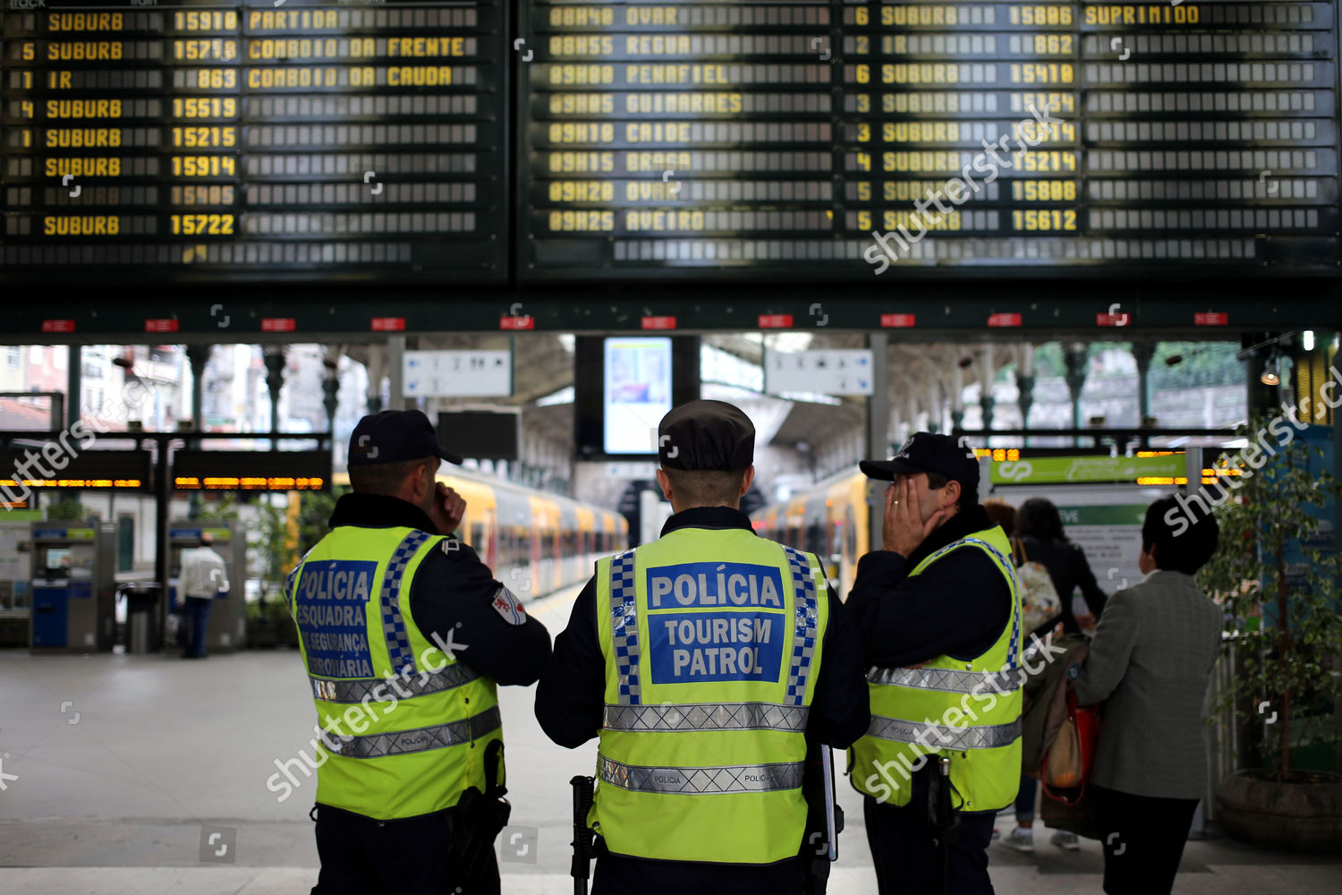 policemen-stand-below-electronic-schedule-board-editorial-stock-photo