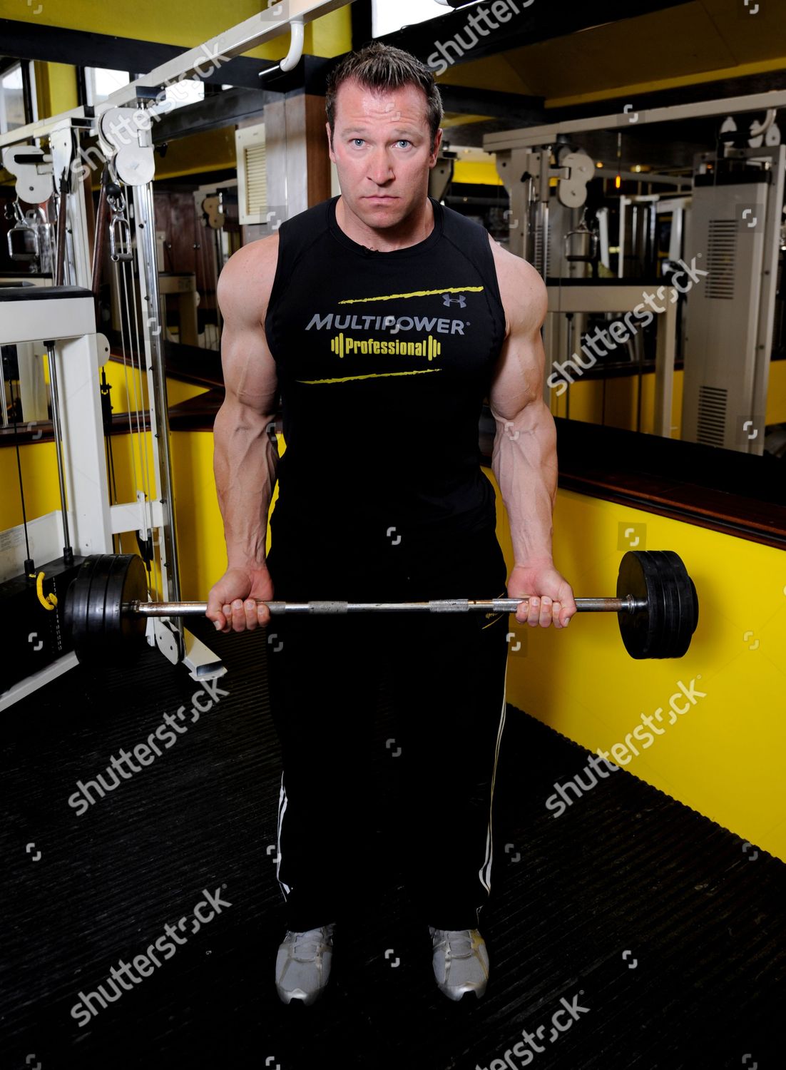 Bodybuilder Gunter Schlierkamp Demonstrates Lifting Technique Editorial