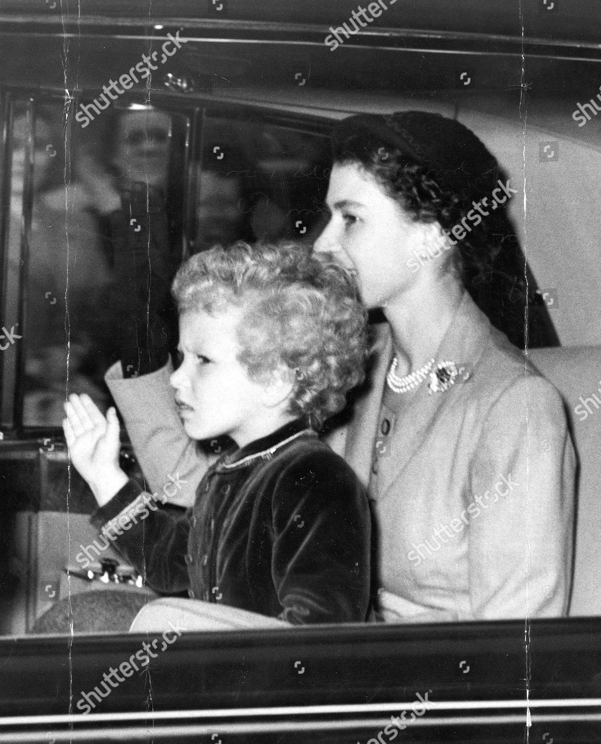 the-queen-elizabeth-ii-smiles-princess-anne-princess-royal-waves-as-they-leave-buckingham-palace-by-car-last-night-for-euston-station-and-the-holiday-journey-to-scotland-1954-shutterstock-editorial-888333a.jpg